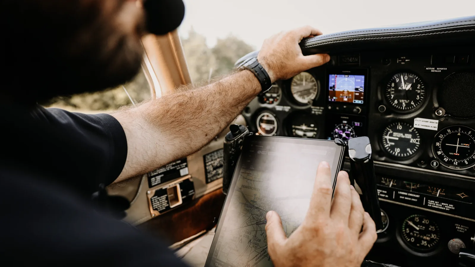 Pilot using an electronic flight bag in a light aircraft cockpit